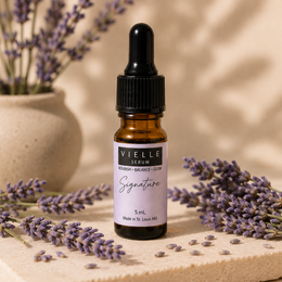 Vielle Serum Signature Formula 5 ml travel mini in amber dropper bottle with lavender label, surrounded by fresh lavender sprigs